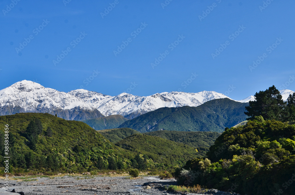 View of South Island New Zealand Mountains Covered with Snow and Foothills and River Bed