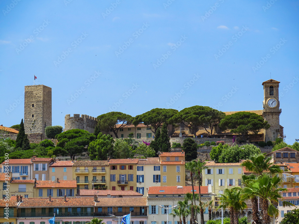 Beautiful view of Cannes castle and colorful houses on a sunny day
