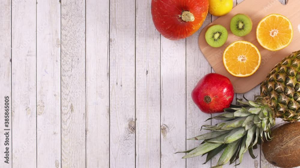 South Fruit and citrus fruits appear with cutting board on wooden theme. Stop motion 