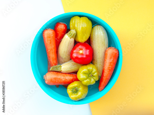 Bowl with vegetables on yellow white background