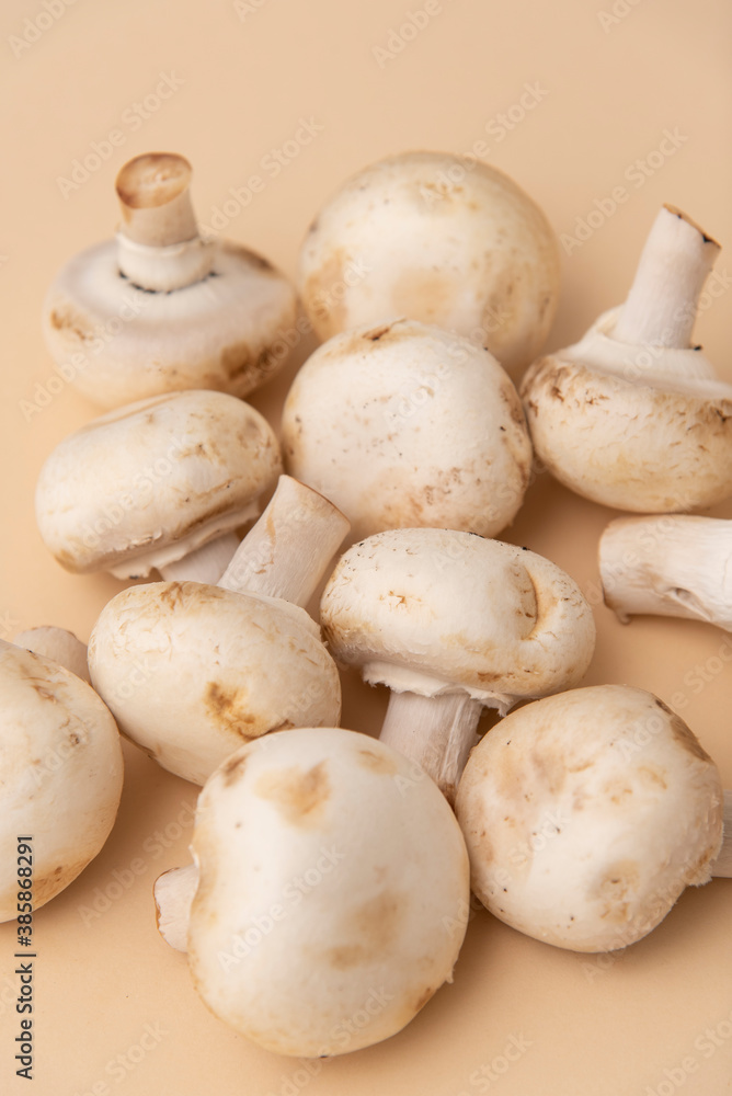 white mushrooms on a wooden background white mushrooms on a wooden background