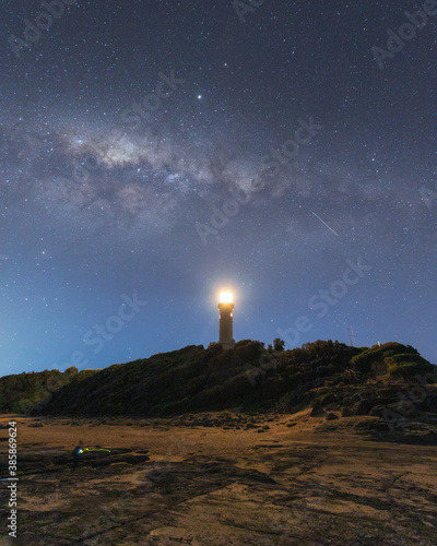 Night view of Norah Head lighthouse with milky way above it.