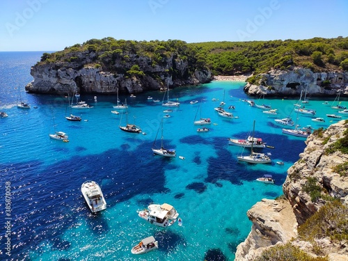 Scenic viewpoint (mirador) of Cala Macarelleta famous paradise beach with turquoise water and pine forests on south coast of Menorca Island, Balearic Islands, Spain.