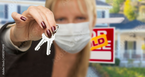 Woman Presenting House Keys...