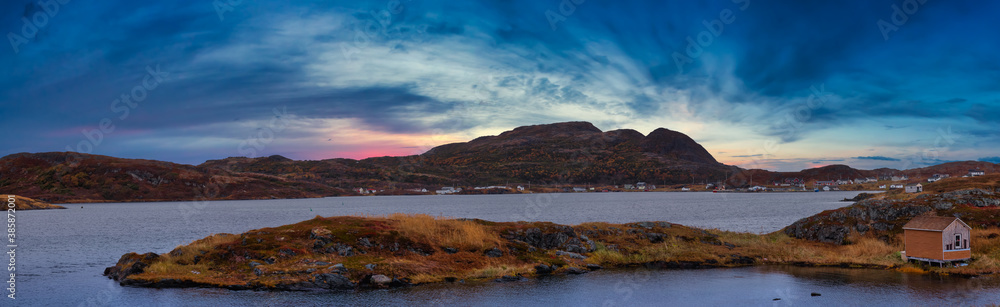 Small town on the Atlantic Ocean Coast. Goose Cove East, Saint Anthony, Newfoundland, Canada. Dramatic Colorful Sunset Artistic Render