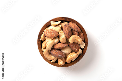 Mixed nut in wooden bowl isolated on white background.