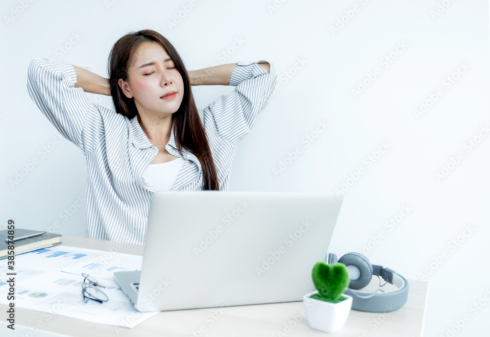Sad Asian businesswoman employee unhappy working with bored on the laptop and chart in the office tired, Office Syndrome Concept Sad Asian businesswoman employee unhappy working with bored on the laptop and chart in the office tired, Office Syndrome Concept