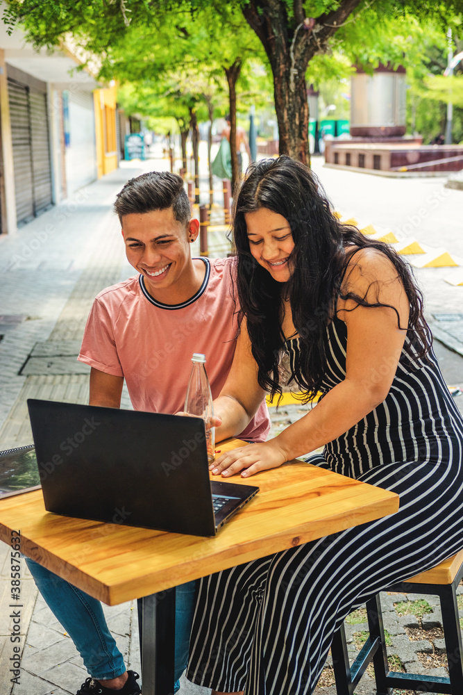 Young Couple Working At Table With Laptop Young Couple Working At Table With Laptop