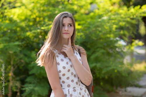 Thoughtful woman standing in park