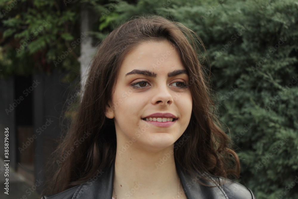 Portrait of a young teenage girl with long hair on the street Portrait of a young teenage girl with long hair on the street