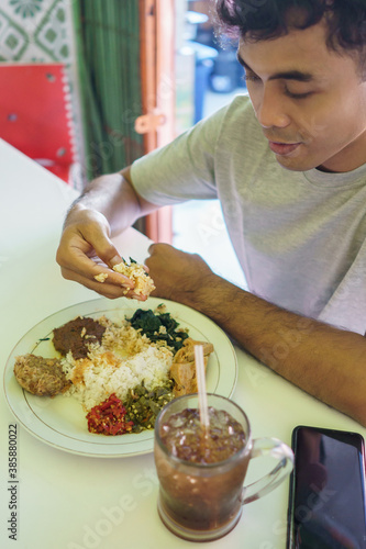 portrait of a man eating traditional food