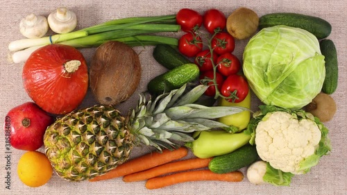 Fresh fruits and vegetables appear and filling the table. Stop motion 