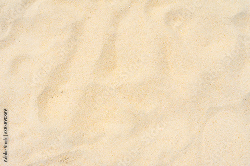 Closeup shot of sand texture on the beach as nature background. Wallpaper and background concept.