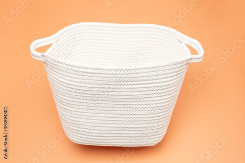 White rope organizing basket on orange vibrant background
