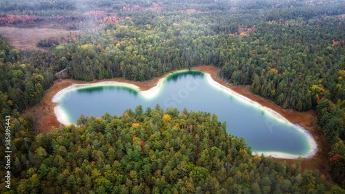 Aerial drone view over McGinnis Lake in Ontario. Autumn forest lake water view. Aerial view of blue lake and green forests. photo