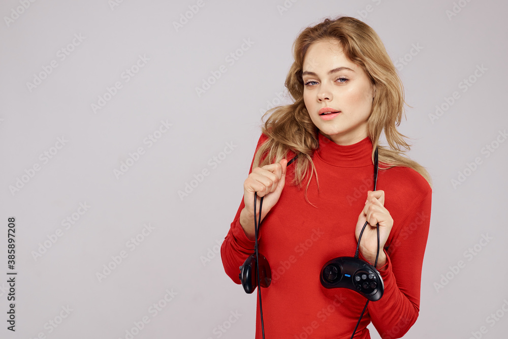 Pretty woman with gamepads playing entertainment leisure lifestyle light background Pretty woman with gamepads playing entertainment leisure lifestyle light background