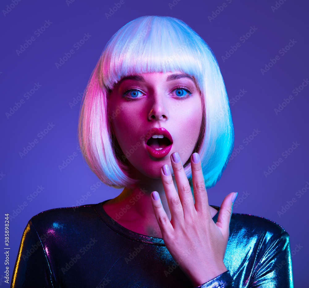 Surprised  Face of glamour girl. Wondered female face in a white wig. Young beautiful woman with a shocked face. Art portrait  of  an young attractive woman with hands at face. Emotional person.