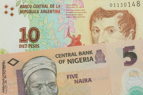 Wallpaper Mural A macro image of a orange, plastic five naira note from Nigeria paired up with a colorful ten peso note from Argentina.  Shot close up in macro. Torontodigital.ca