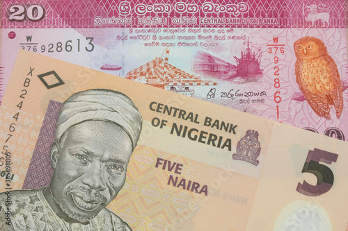 Wallpaper Mural A macro image of a orange, plastic five naira note from Nigeria paired up with a pink and white twenty rupee bank note from Sri Lanka.  Shot close up in macro. Torontodigital.ca