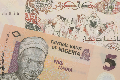 Wallpaper Mural A macro image of a orange, plastic five naira note from Nigeria paired up with a beige 200 Algerian dinar bank note.  Shot close up in macro. Torontodigital.ca