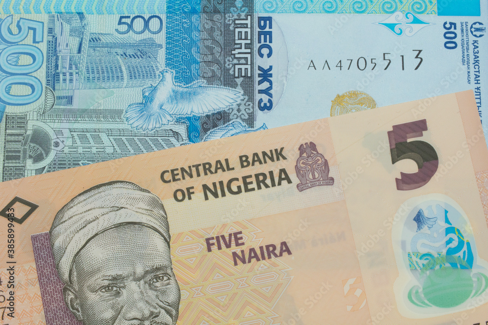 A macro image of a orange, plastic five naira note from Nigeria paired up with a blue, plastic five hunded tenge bank note from Kazakstan.  Shot close up in macro.