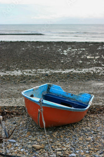 Wooden rowing boat beached on the shore.