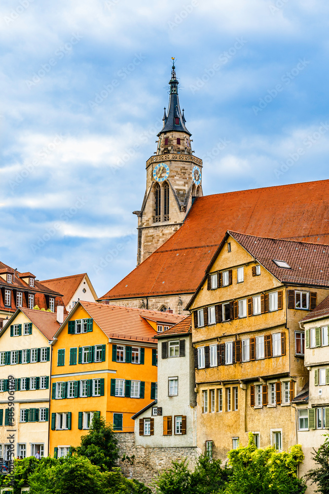 Fototapeta premium Medieval late gothic St. George's Collegiate Church (Stiftskirche) and colorful old buildings cityscape in the old town of Tübingen, Baden-Württemberg, Germany