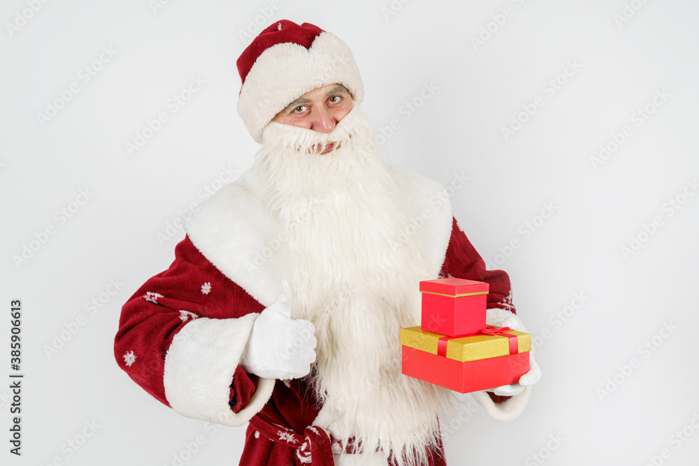 Santa Claus holds a gift in his hand, and the second makes a hand gesture - class. Isolated on white