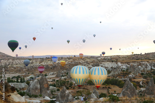 Beautiful colourful balloons flight in the morning in Cappadocia in Turkey. Amazing landscape background.