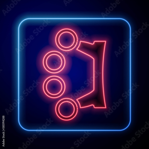 Glowing neon Brass knuckles icon isolated on blue background. Vector.