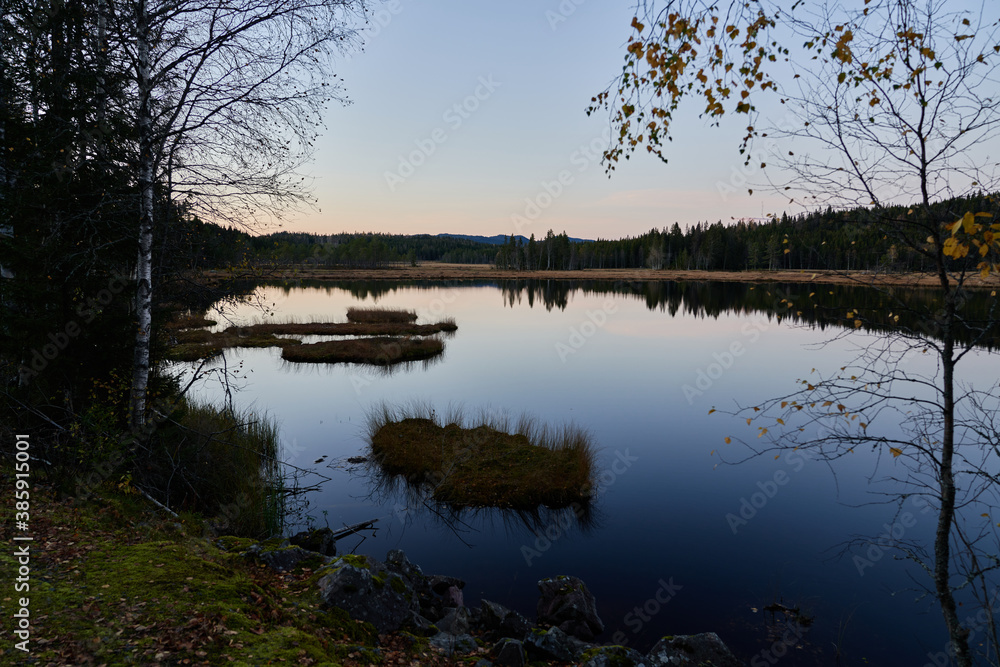 Triungsvanna, Oslomarka, Norway. Nature reserve. Shot in golden/blue hour in october. A crisp and cold evening in Nordmarka. This lake and forest is only a few kilometers from down town city of oslo. Triungsvanna, Oslomarka, Norway. Nature reserve. Shot in golden/blue hour in october. A crisp and cold evening in Nordmarka. This lake and forest is only a few kilometers from down town city of oslo.