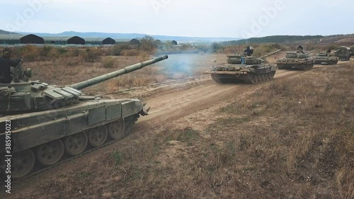 Soldiers and transport vehicles on muddy road aerial