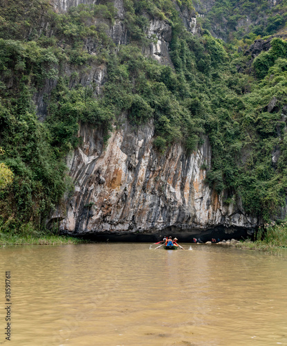 Traditional paddle-boat trip along the Ngo Dong River with exploring the grottoes and limestone karsts of Tam Coc.