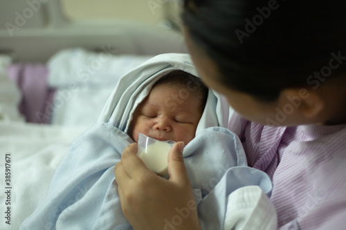 Medium Shot New Born Baby Girl  Drinking Milk from Cup