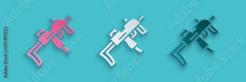 Paper cut MP9 submachine gun icon isolated on blue background. Automatic weapon. Paper art style. Vector.