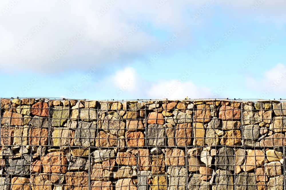 Behind the stone fence, the sky is blue. Freedom behind the fence. Copy space.