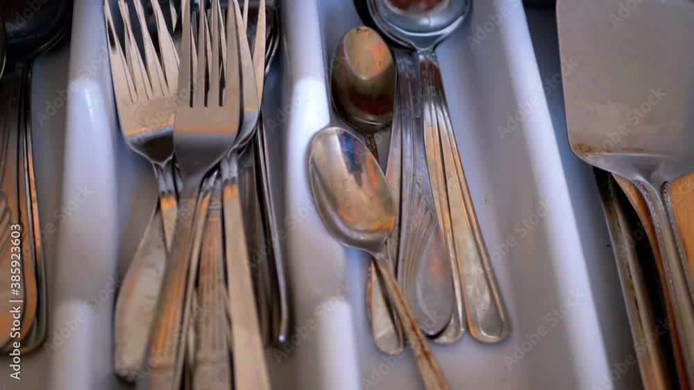 Set of Dirty Cutlery, Spoons, Forks, in a Drawer on Home Kitchen Set of Dirty Cutlery, Spoons, Forks, in a Drawer on Home Kitchen