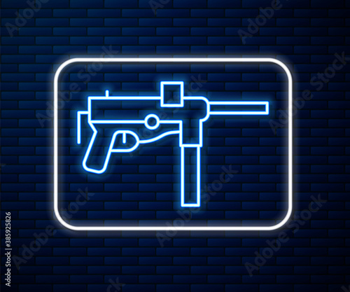 Glowing neon line Submachine gun M3, Grease gun icon isolated on brick wall background. Vector.