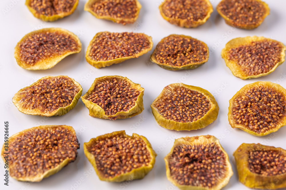slices of dried figs on a white background. dried fruits. eco. top view. slices of dried figs on a white background. dried fruits. eco. top view.