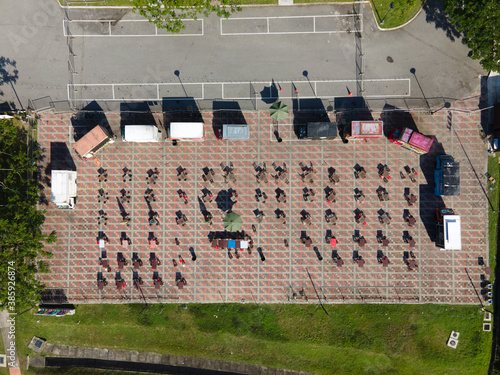An aerial top down view of a food truck park area