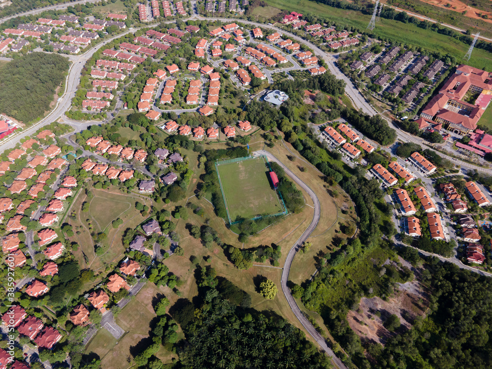 Aerial view of football field in residential area.