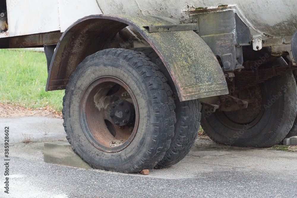 big black dirty wheels on a gray truck on the street big black dirty wheels on a gray truck on the street