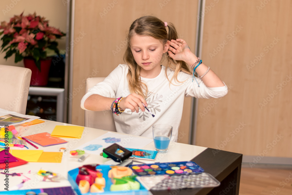 little child enjoying the leisure time while creating christmas card craft
