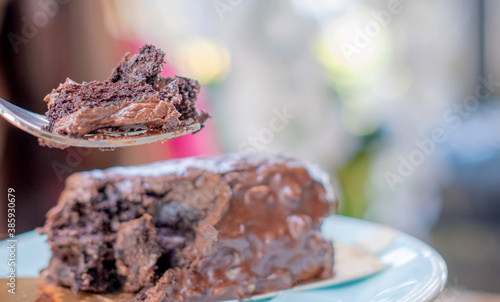 Woman is eating chocolate browine cake. Copy space.