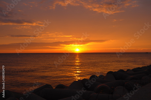 Wallpaper Mural Sunset over Yellow Sea. Golden sky with clouds. Torontodigital.ca