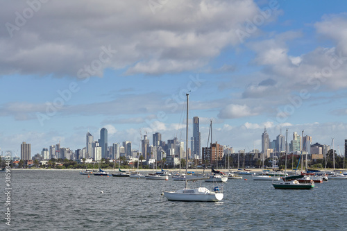 Several Boats docked in front of the Melbourne Skyline