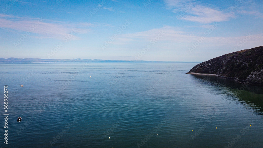 Calm sea with llanbedrog headland north wales Calm sea with llanbedrog headland north wales