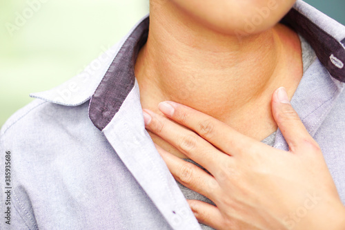 Asian woman have abnormal of thyroid gland at the right throat (Hyperthyroidism, Overactive Thyroid) : Health, illness and medical concept.