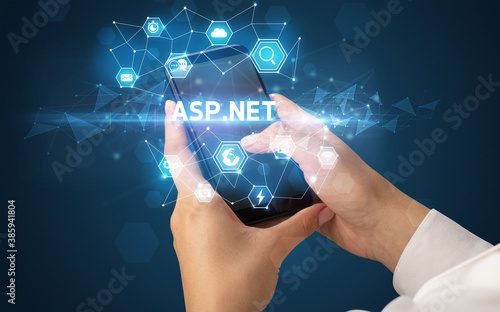 Female hand holding smartphone with ASP.NET inscription, modern technology concept