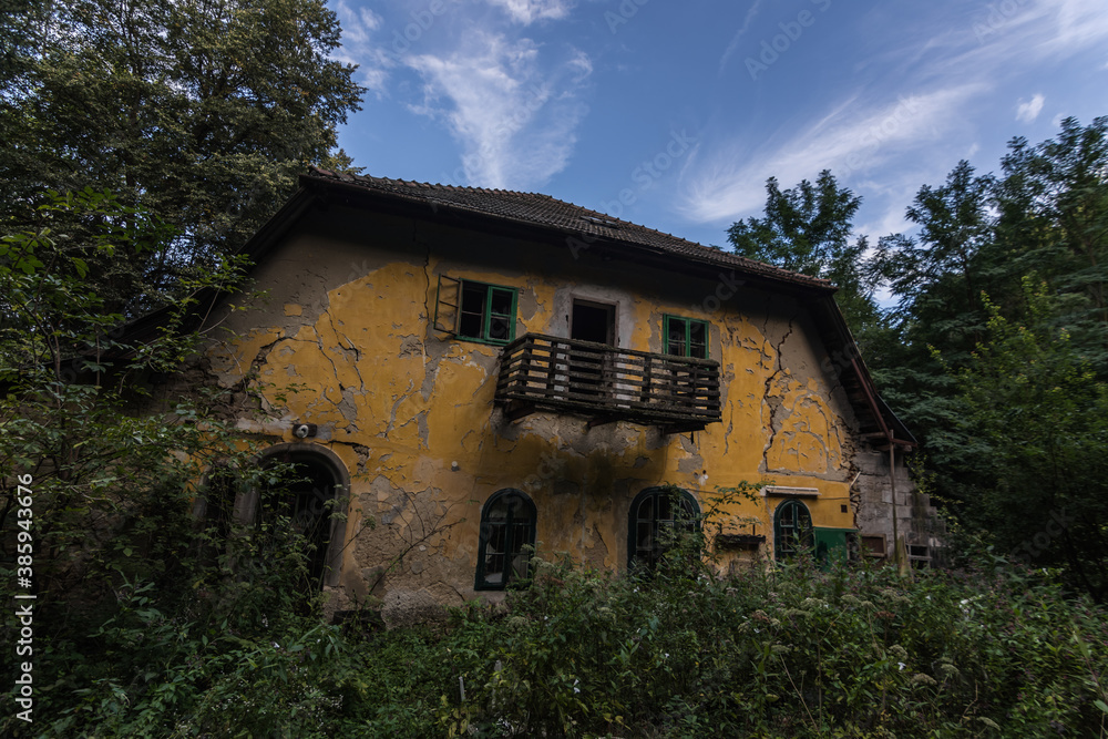 abandoned yellow house with many cracks